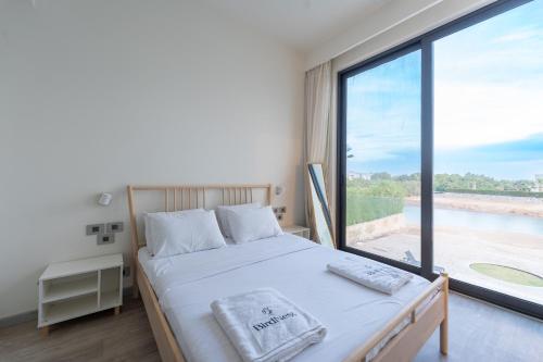 a bedroom with a bed and a large window at El Gouna - BIRD NEST in Hurghada