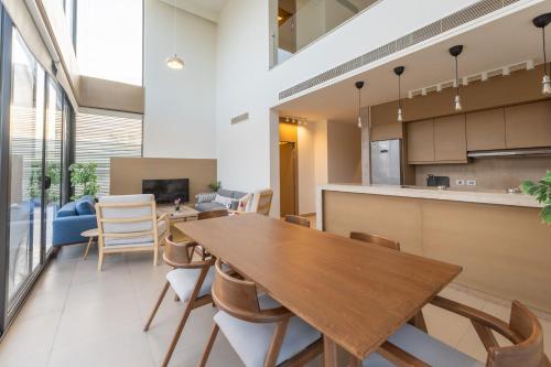 an open kitchen and dining room with a wooden table and chairs at El Gouna - BIRD NEST in Hurghada