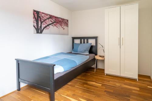 a bedroom with a bed with a picture on the wall at Ausblick Maisenbach, Talstraße in Bad Liebenzell