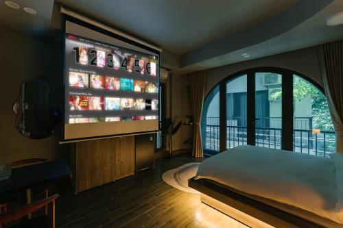 a bedroom with a large screen in a room at My Home Westlake Hanoi in Hanoi