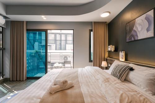 a bedroom with a large bed with a hat on it at My Home Westlake Hanoi in Hanoi