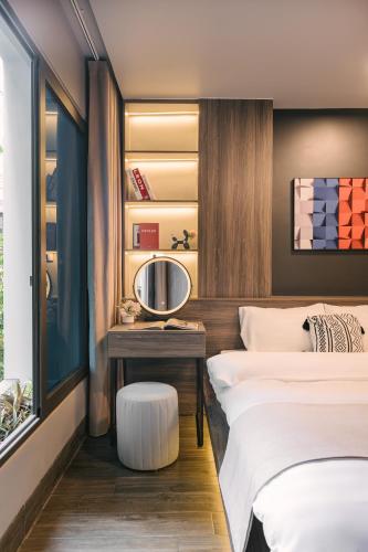 a bedroom with two beds and a table with a mirror at My Home Westlake Hanoi in Hanoi