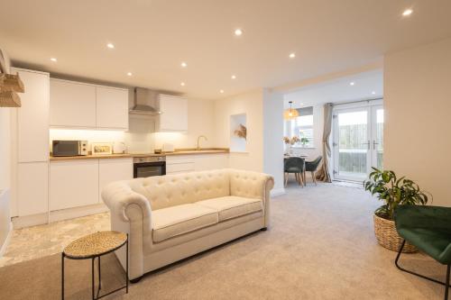 a living room with a couch and a kitchen at Apartment 1, King's Court in Scarborough