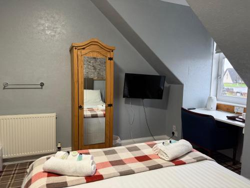 a hotel room with a bed and a mirror at Gothenburg Hotel in Rosyth