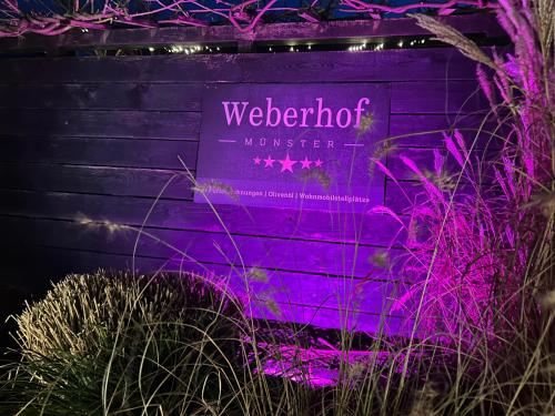 a purple sign on a purple wall with purple lights at Weberhof - Münster 6 in Münster