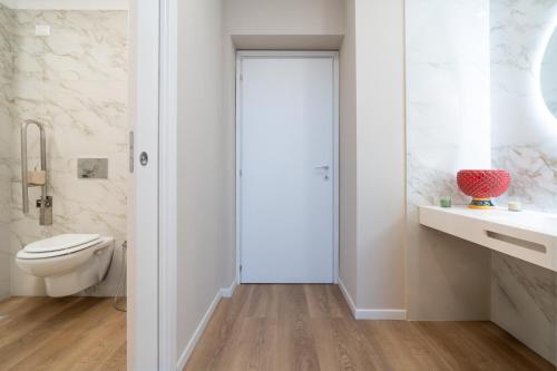 a bathroom with a toilet and a sink at Archimedes suites in Catania