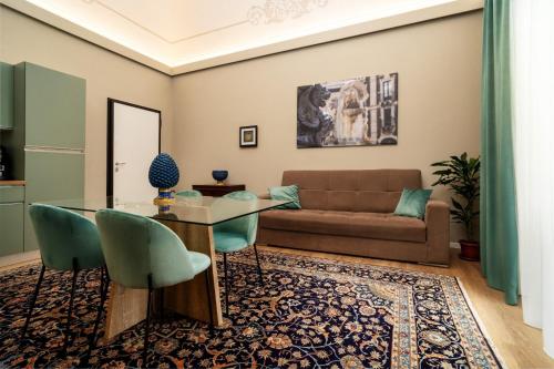 a living room with a glass table and a couch at Archimedes suites in Catania