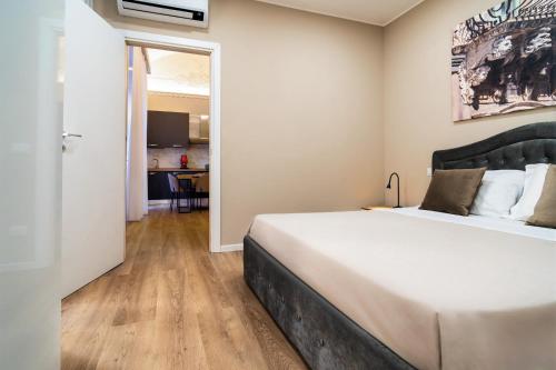 a bedroom with a large bed in a room at Archimedes suites in Catania