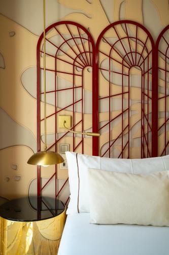 a bedroom with a bed with a red headboard at Room Mate Macarena, Madrid Gran Vía in Madrid