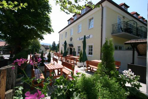a building with wooden benches in front of it at Hotel Mayerling in Mayerling