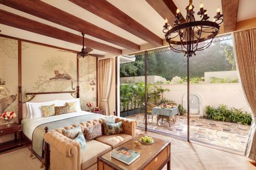 a bedroom with a bed and a large window at Sawai Madhopur Lodge - IHCL SeleQtions in Sawāi Mādhopur