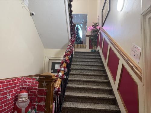 a staircase in a house with christmas decorations at Gothenburg Hotel in Rosyth