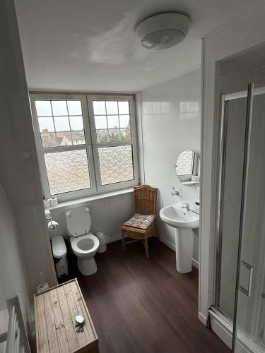 a bathroom with a toilet and a sink at Gothenburg Hotel in Rosyth