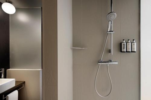 a bathroom with a shower with a shower head at Wilson Boutique Hotel in Barcelona