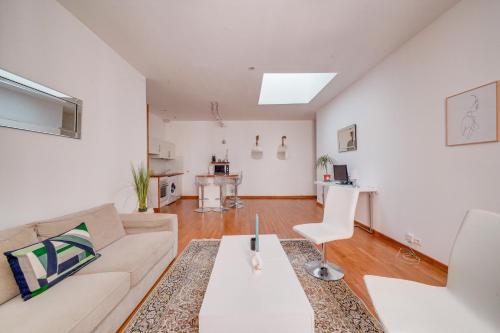 un salon avec un canapé et une table dans l'établissement MDOR - Le Montesquieu en bail mobilité, à Bordeaux