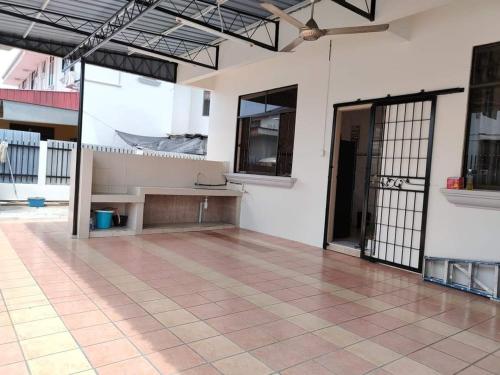 an empty room with a table and a large window at My homestay in Tawau