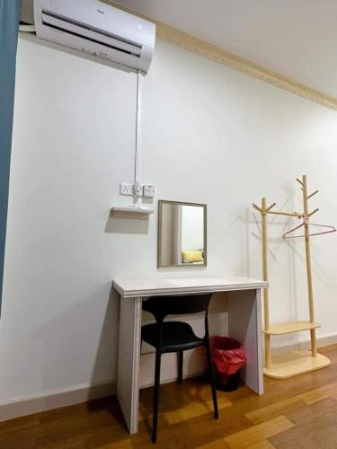 a desk with a mirror and a chair in a room at My homestay in Tawau