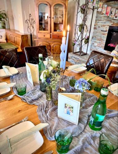 a wooden table with green bottles on top of it at life-stegersbach Suites in Stegersbach
