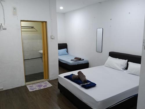 Ein Bett oder Betten in einem Zimmer der Unterkunft JSW PRAMLee Georgetown Penang