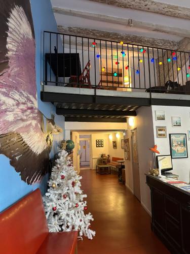 a christmas tree in a living room with a staircase at Hostel Vertigo Vieux-Port in Marseille