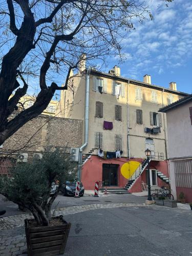 a large white building with a staircase in front of it at Hostel Vertigo Vieux-Port in Marseille
