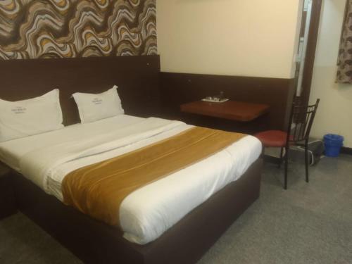 a bedroom with a large bed with a wooden headboard at Hotel nav bharath residency in Hyderabad