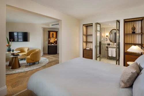 a bedroom with a bed and a living room at Small Luxury Hotel Ambassador Zurich in Zürich