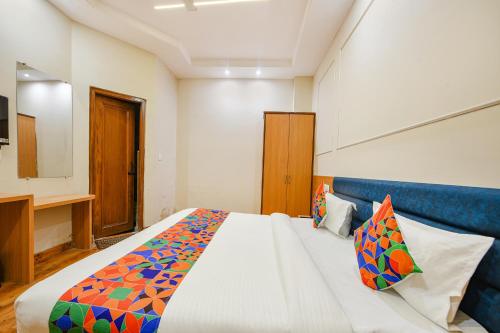a bedroom with a large bed and a television at FabHotel Alpine Tree in Amritsar