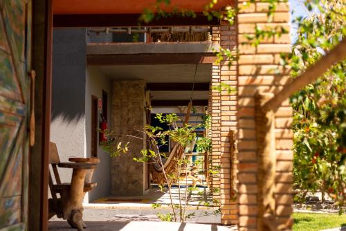 an open door of a house with a patio at Pousada Nascer da Lua in Fortim