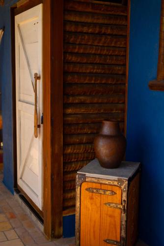 a vase sitting on top of a box next to a door at Pousada Nascer da Lua in Fortim
