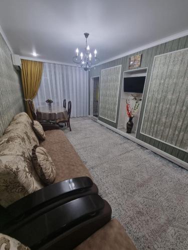 a living room with a couch and a fireplace at 2-ка, центр города in Taraz