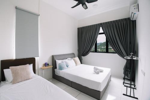 a bedroom with two beds and a window at NEW The Sun 3Bedrooms 10pax 2CP in Bayan Lepas