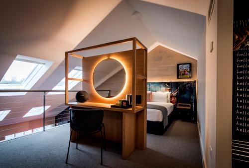 a bedroom with a large mirror and a bed at Ovolo Woolloomooloo in Sydney