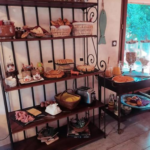 a shelf filled with different types of food on at Via Bahia - Maison d'hôtes in Biscarrosse