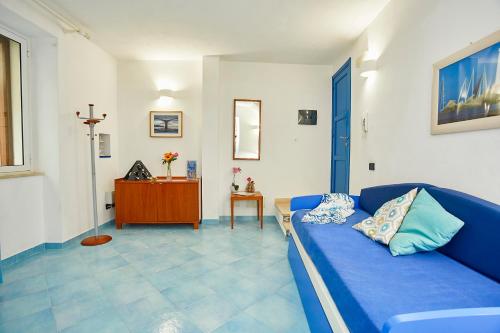 a living room with a blue couch and a table at Appartamenti Rosa Dei Venti in Trapani
