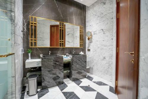 a bathroom with two sinks and a mirror at Velero Hotel Doha Lusail in Doha