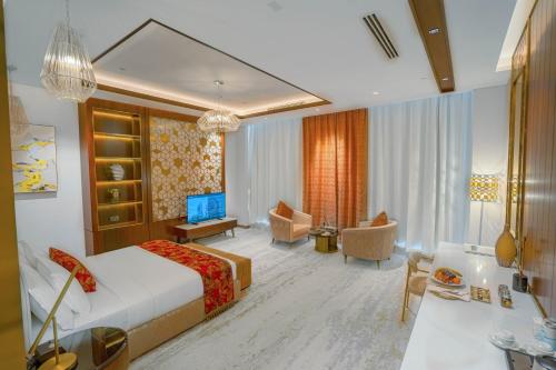 a bedroom with a bed and a living room at Velero Hotel Doha Lusail in Doha