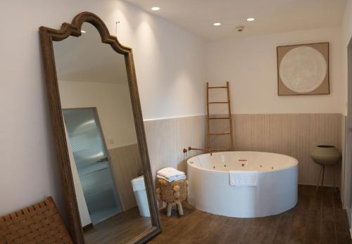 a bathroom with a large mirror and a tub at Estate Spa Boutique Hotel - Adults Only in Rechovot
