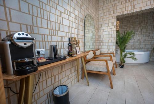 a kitchen with a table with a stove and a chair at Estate Spa Boutique Hotel - Adults Only in Rechovot