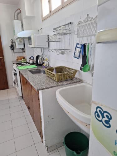 a small kitchen with a sink and a tub at Apartment Chunin Depart in Salta