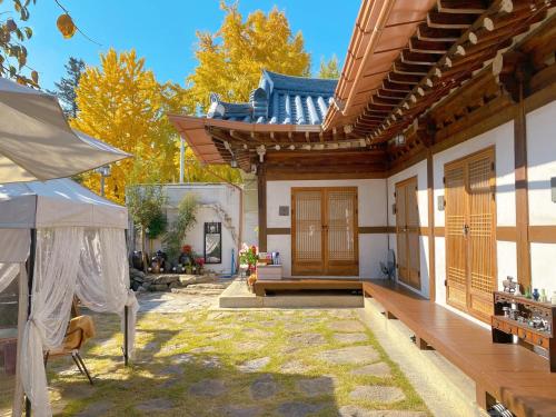 a patio of a house with a bench and a building at Pungnam House in Jeonju