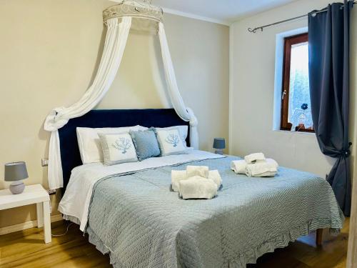a bedroom with a blue and white bed with a canopy at Bellavista Vacation in Olbia