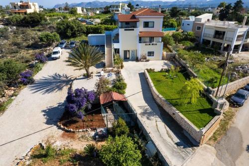an aerial view of a house with a driveway at Villa Aitheras with sea views and garden in Stérnai