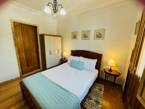 a bedroom with a large bed and two night stands at Casa Torino in Santiago