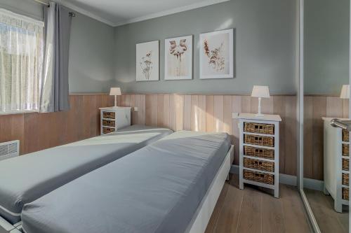 a bedroom with a large bed and two night stands at Rietpanne Gv06 in Sint-Idesbald