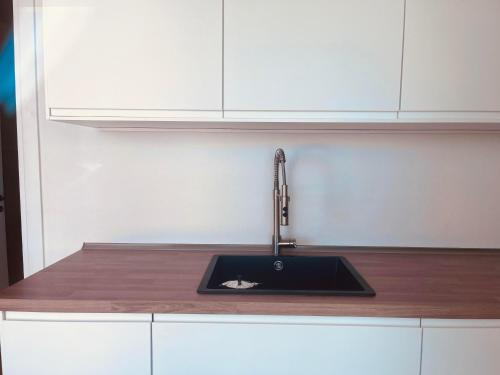 a kitchen counter with a sink and a faucet at Dimora Vereto in Morciano di Leuca