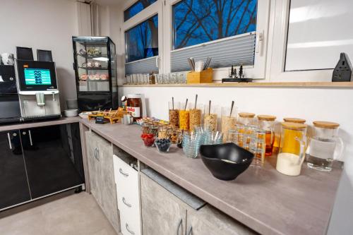 a kitchen with a counter with many jars on it at Sonnenschein Hotel & Apartments in Heilbad Heiligenstadt