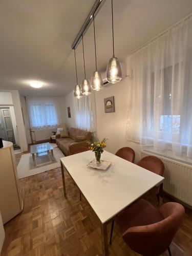 a living room with a white table and chairs at Apartment SAYA in Banja Luka