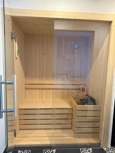 a sauna with a glass door in a wooden room at Panta Rei Camere di Charme e Spa in Taranto