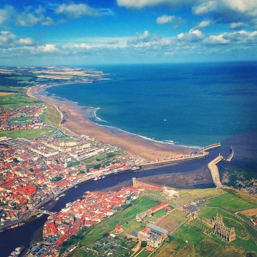 an aerial view of a city next to the ocean at The Lansbury - Whitby in Whitby